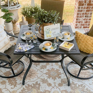 Outdoor table and chairs on a patterned rug