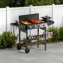 outdoor grill and griddle combo with food and accessories on a patio