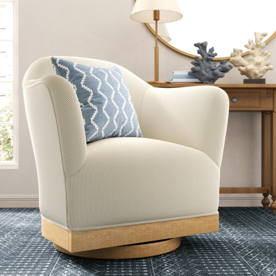 Beige armchair with a blue patterned pillow in a room with a desk and decor.
