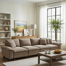 Living room with a beige sectional sofa, coffee table, and decorative items.