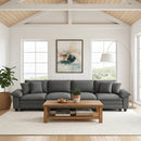 Gray sectional sofa in a living room with a wooden coffee table and decor