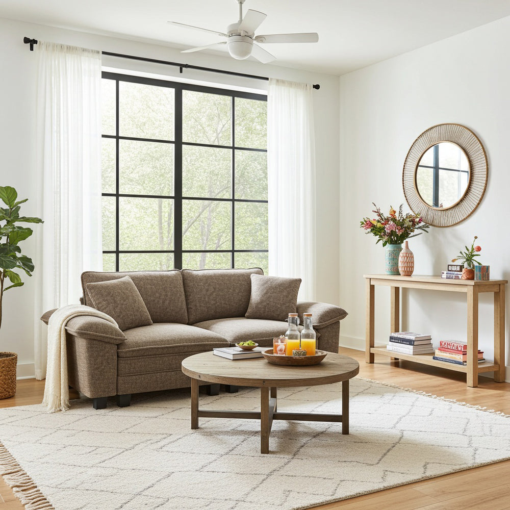 a brown sectional sofa loveseat for the living room, a round wooden coffee table, and decorative items.