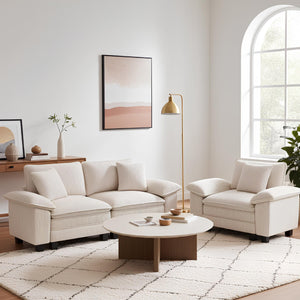 Modern living room with beige sofa set, coffee table, and decorative elements.