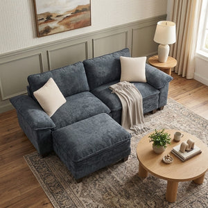 A small sofa in dark blue stands in a living room corner.