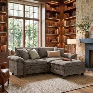 A plush smoky-grey 80-inch sofa with ottoman, styled in a study.