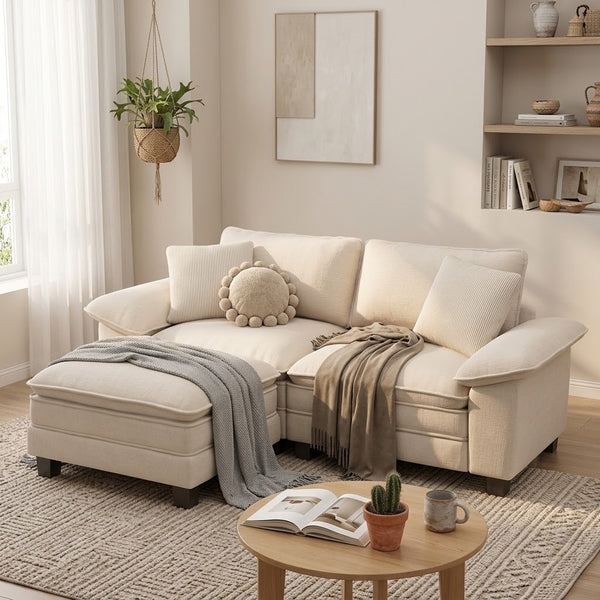 A cream-colored sofa for small living rooms. The sofa is styled with several throw pillows in the same color as the sofa.