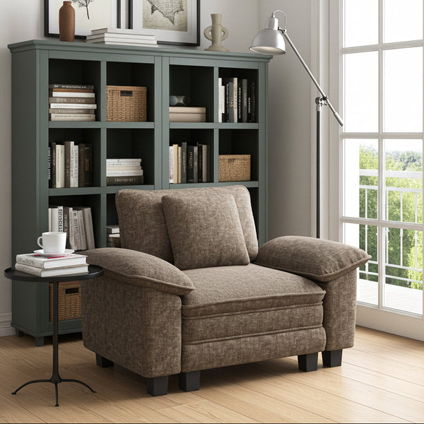 Sofa armchair in a living room with a bookshelf and a large window.