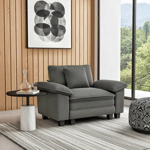 Gray armchair in a modern living room with a side table and abstract art on the wall.