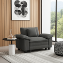 Gray armchair in a modern living room with a side table and abstract art on the wall.