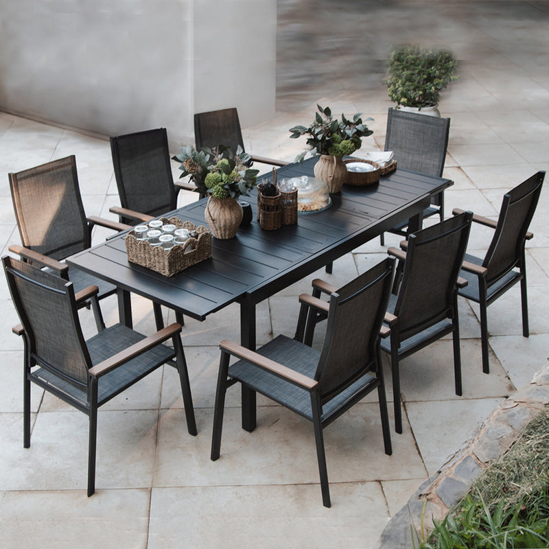 Outdoor dining set with a table and chairs on a patio.