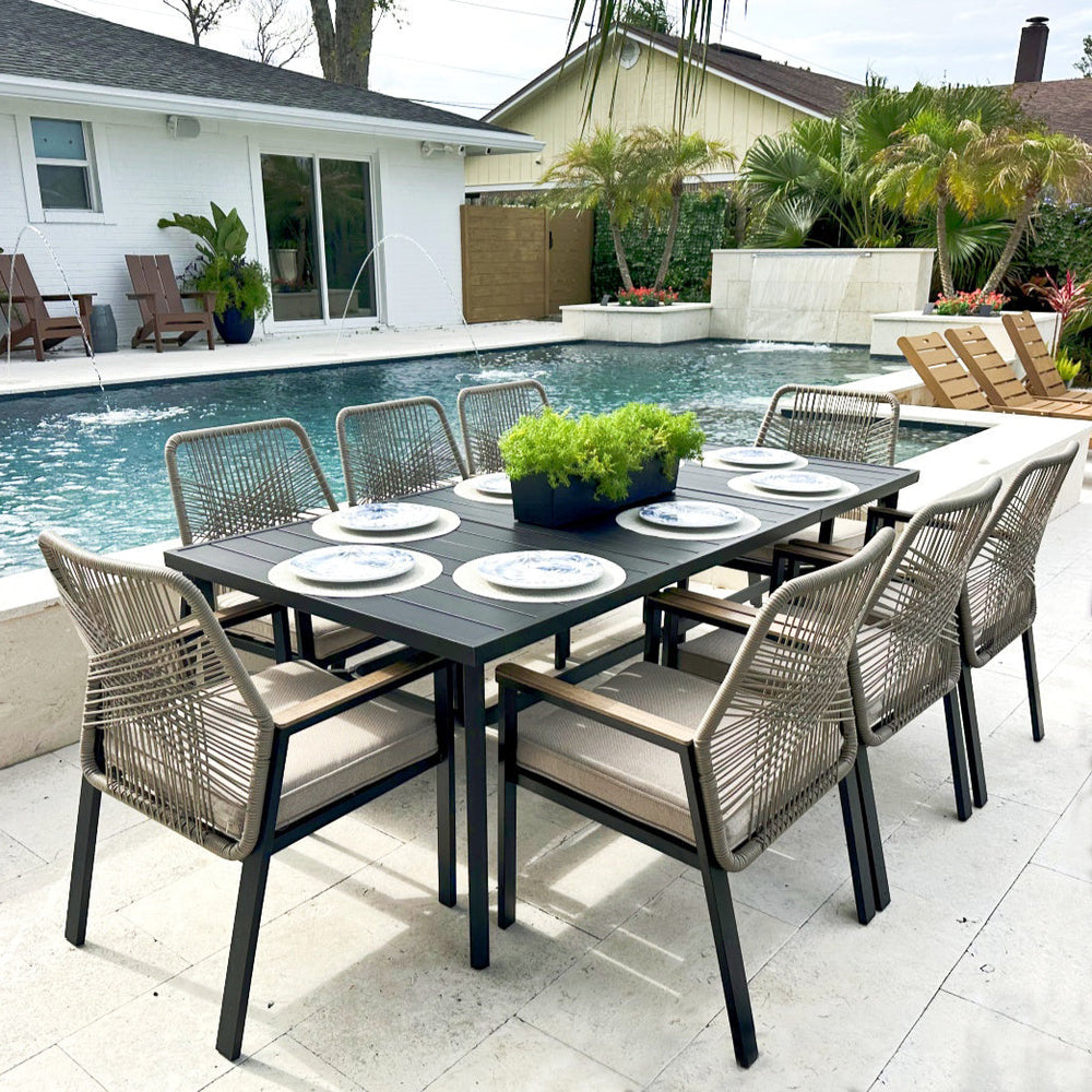 Outdoor dining set with table and rope art chairs by a poolside