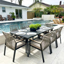 Outdoor dining set with table and chairs by a poolside