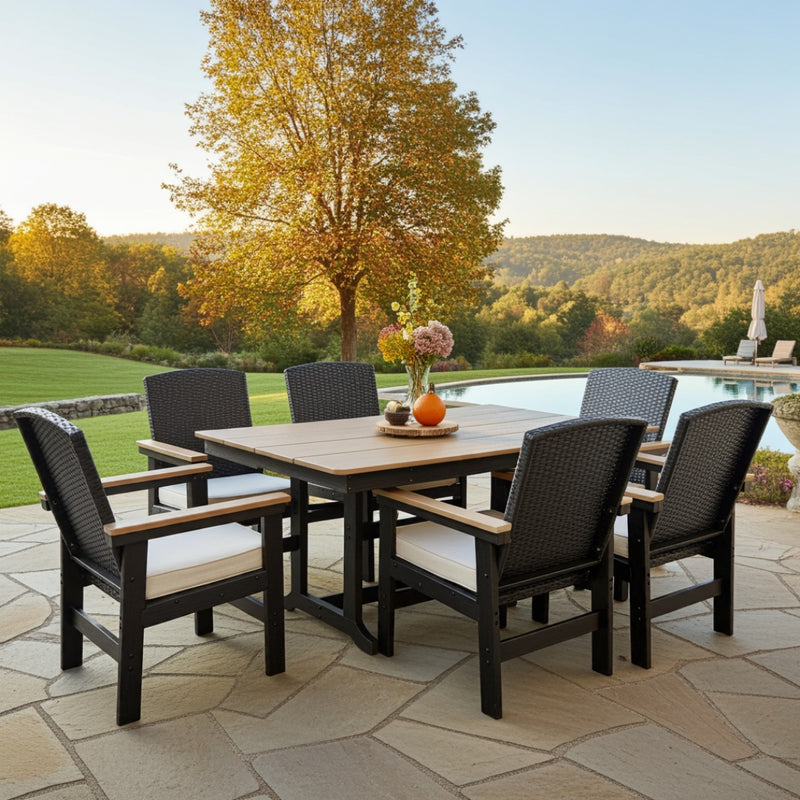 Outdoor patio set with table and chairs by a poolside