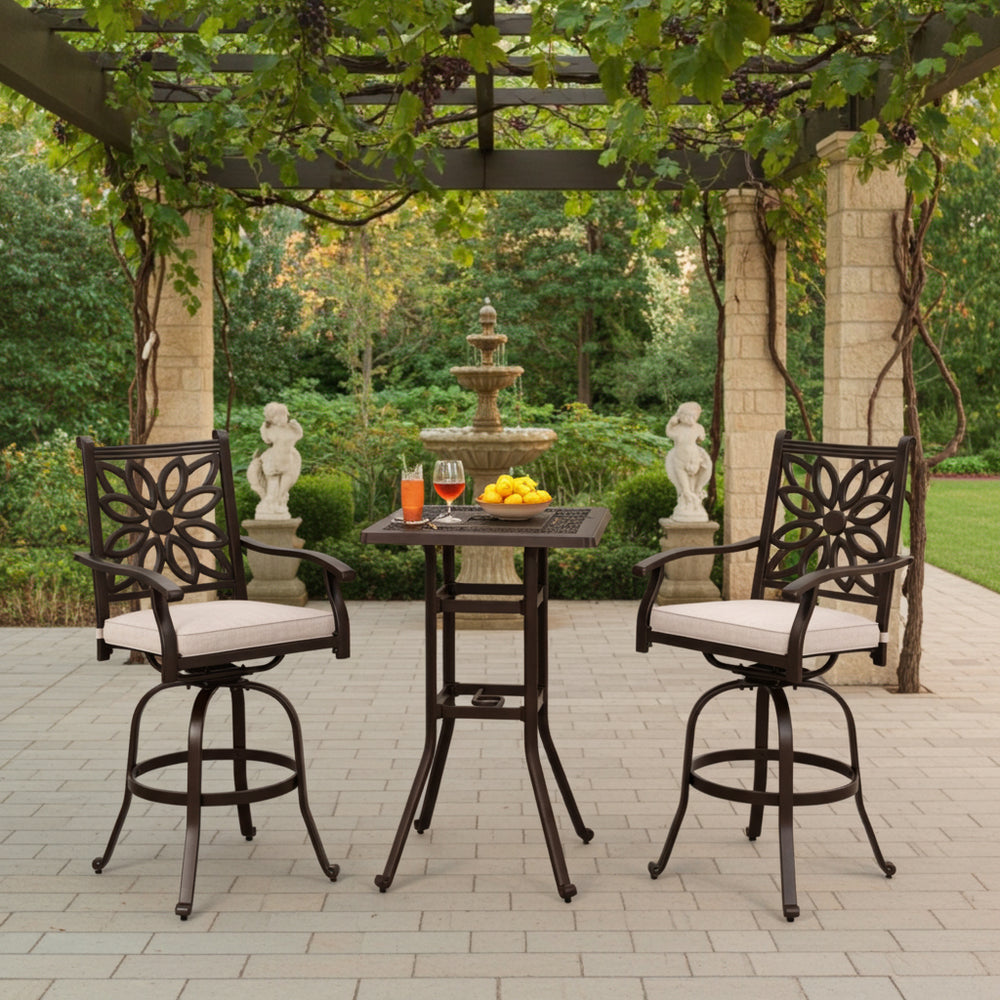 cast aluminum barstools set with two counter-height chairs and a table under a pergola with a fountain in the background.