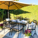 Outdoor dining set with a table, 6 chairs, and a large yellow umbrella on a sunny day.