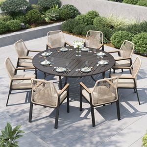 Outdoor dining set with a round table and eight rattan chairs on a patio.