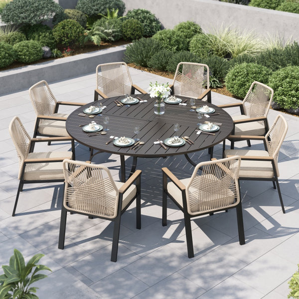 Outdoor dining set with a round table and eight rattan chairs on a patio.