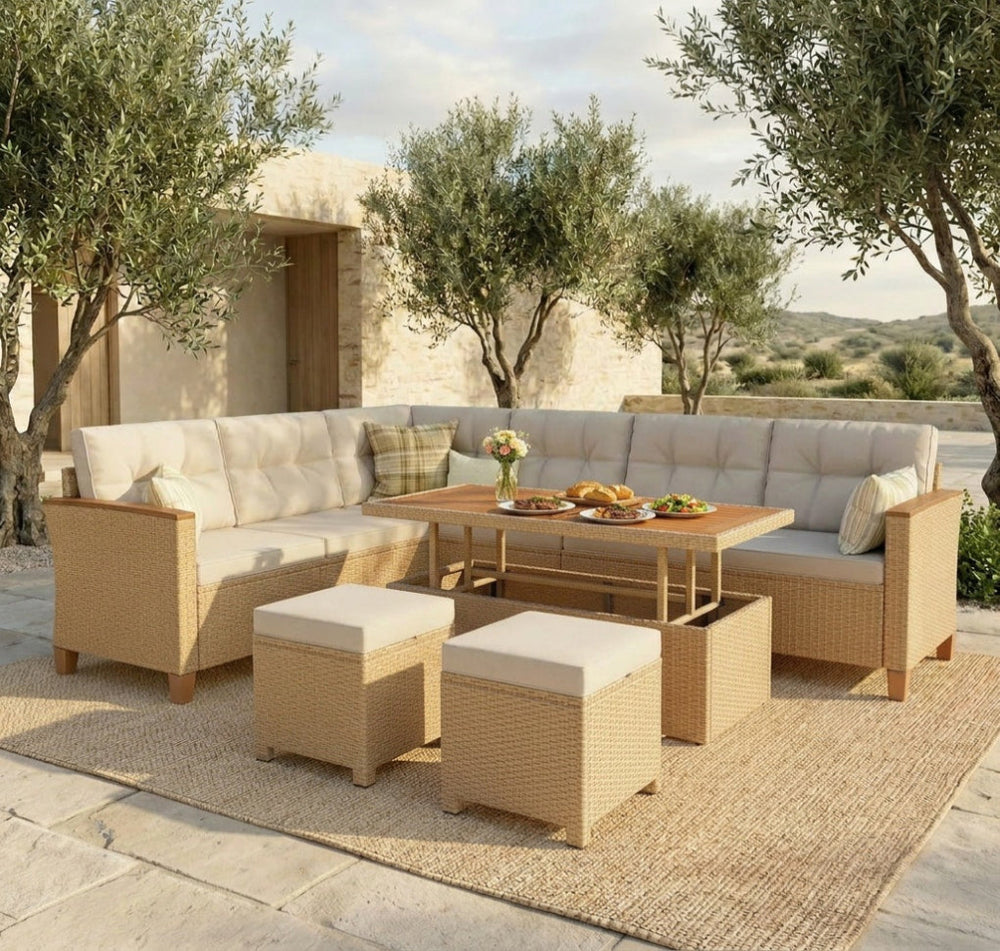 Outdoor patio furniture set with beige cushions and a small table on a stone patio.